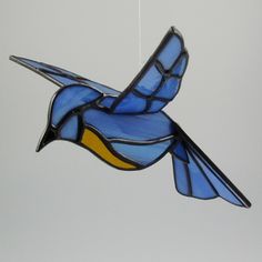 a stained glass bird hanging from the ceiling