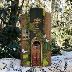 an old book is sitting on top of a doily covered table with white lace