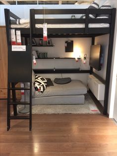 a loft bed with a couch underneath it