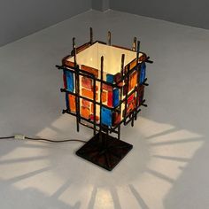 a lamp that is sitting on top of a white floor with no one around it