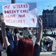 Person with red hair photographed from behind holding a sign reading ‘my uterus doesn’t care about your religion’. Sign has a uterus sticking up a middle finger Career Goals, Relationship Memes, Care About You