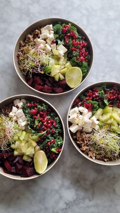 three bowls filled with food on top of a white countertop next to each other