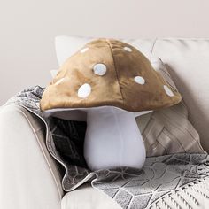 a mushroom pillow sitting on top of a white couch