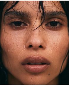 a close up of a woman's face with frecks on her hair