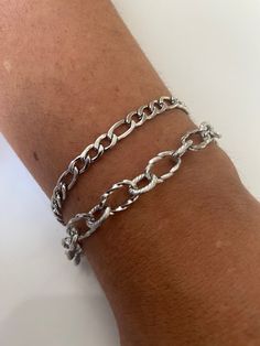 Welcome to my shop. This bracelet is perfect wear for everyone.  Suitable from ages 10 to 100 years old. >> Chunky Chain - 6mm x 8mm, 7mm x 11mm >> Figaro Chain: 5mm >>Clasp: Lobster >>Material: Stainless Steel. This is a Custom order. If you are buying both necklaces, they both come at a default length of 8''. If you would prefer another length please leave a message at checkout. The Model in the photo is wearing a chain length of 8 inches. If you have concerns about your skin colour and the gold colour, please agree with yourself first before buying. We don't know you nor are we magicians to know what shade of gold you like. Please message me for any enquiries.  Thank you Silver Figaro Chain Layered Bracelet, Men & Women Chunky Chain Bracelet, Stainless Steel Bracelet, Stackable Bracelet Custom Silver Jewelry, Silver Figaro Chain, Layered Bracelet, Bracelet Men, Figaro Chains, Shades Of Gold, Figaro Chain, Stackable Bracelets, Layered Bracelets