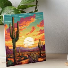 a desert scene with cactus and sunset art board print