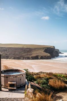 a hot tub sitting on top of a sandy beach