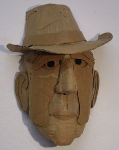 a cardboard mask with a hat on it