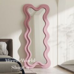 a mirror that is next to a bed in a room with white walls and flooring