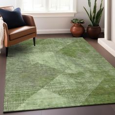 a living room with a chair, rug and potted plant