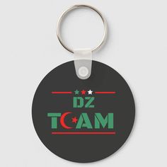 a black round keychain with the word dz team on it and stars