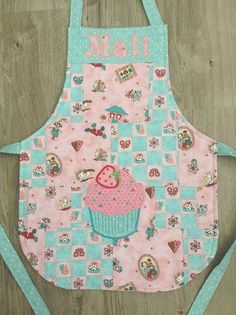 a pink and blue apron with a cupcake on it