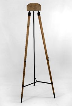 a wooden and metal tripod floor lamp on an isolated white background with clippings