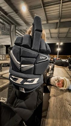 a person wearing a hockey goalie's gloves