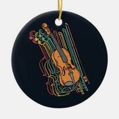 a black ornament with a violin and music notes on it's side