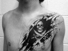 a man's chest with blood splattered on it and a skull in the middle