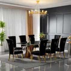 a dining room table with black chairs and a chandelier