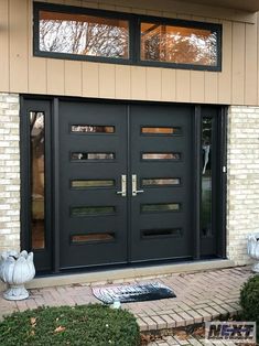 the front entrance to a house with two large doors