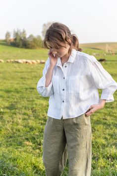 "An Oversized Linen Shirt is for sure a wardrobe staple for all times. Classic modest style is moderately embellished with stylish patch pockets. This white button up shirt can be favorably combined both with loose and classic bottoms. A slightly cropped design delicately hints at the waistline. Thus, it creates a perfect balance to a current-day trend on oversized clothes. DETAILS ⚬ Spread collar. ⚬ Patch pockets are decorated with handmade fancy stitches. ⚬ Button fastening. ⚬ 3/4 sleeve. ⚬ Sl White Linen Shirt Outfit, Linen Shirt Outfit, Oversized Linen Shirt, Oversized Clothes, Modest Style, White Linen Shirt, Linen Blouse, Shirt Button, Crop Shirt