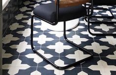 a black and white tiled floor with chairs