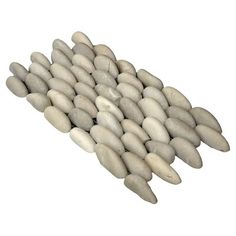 a pile of white rocks sitting on top of each other in front of a white background