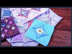 several different colored pieces of fabric sitting on top of a wooden table