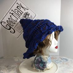 a mannequin head wearing a blue knitted hat