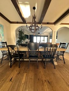 a dining room table with chairs and a chandelier