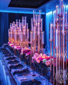 a long table with candles and flowers on it