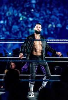 a man standing on top of a wrestling ring