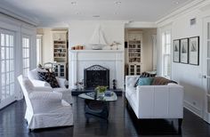 a living room filled with furniture and a fire place in the middle of a room