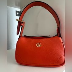 Gorgeous! Brand New! Comes With Box And Dustbag! Aphrodite Leather Shoulder Bag Aphrodite Leather Shoulder Bag From Gucci Featuring Orange Leather, Gold-Tone Logo Plaque, Top Zip Fastening, Adjustable Top Handle And Main Compartment Gucci Shoulder Bag With Branded Hardware, Trendy Gucci Shoulder Bag With Detachable Strap, Trendy Gucci Evening Bags, Bags Gucci, Orange Leather, Gucci Bags, Aphrodite, Gucci Bag, Mini Bag