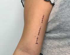 a woman's arm with the word love written in cursive writing on it