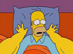 the simpsons is laying in bed with his hands up