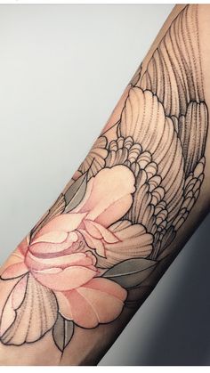 a woman's arm with a flower and wings tattoo design on the left forearm