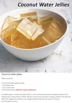 a white bowl filled with ice cubes on top of a table