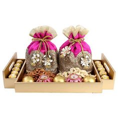 two bags filled with gold and pink decorations