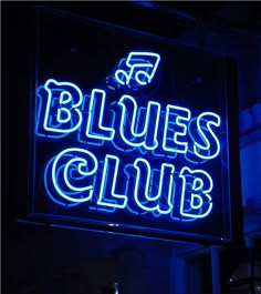 a neon sign that says blues club on it