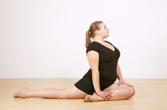 a woman is sitting on the floor doing yoga