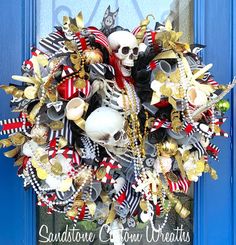 a wreath that is on the front door with skulls and other items attached to it