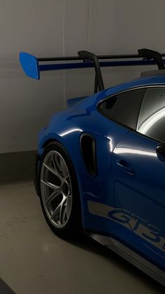 a blue sports car parked in a garage