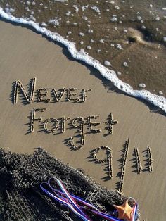 a message written in the sand next to an orange and blue rope on the beach