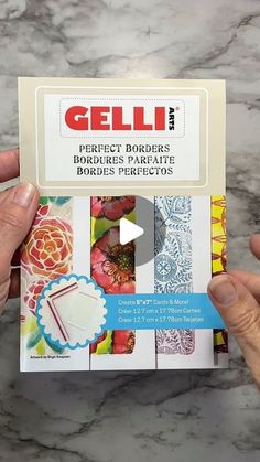 a person holding up a package of gelli perfect borders for paperless cards and envelopes