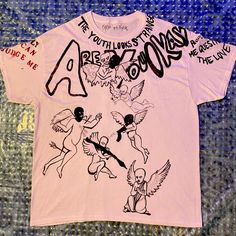 Custom 1 Of 1: Made By Nyala Hand Painted/Drawn Angels Scene With Quotes On Sleeves, Collar, And Chest With Accents Of Glitter On A 100% White Cotton T-Shirt. (Yes, Safe To Wash!) Hand Painted White T Shirts, Pink Cotton Top With Graffiti Print, Lilo And Stitch Shirt, Dare Shirt, Red Fishnets, Shirt Painting, Acid Wash Shorts, T Shirt Painting, Yellow Tees