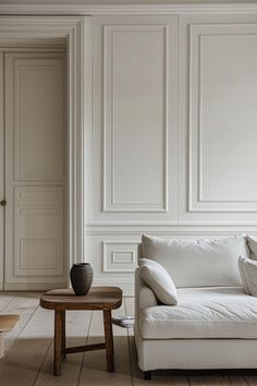 a living room with white walls and wood flooring