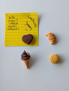 four different types of pastries are on a piece of yellow paper next to a note