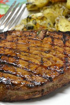 a steak and potatoes on a plate with a fork