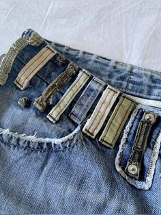 an old pair of jeans with holes in the back pocket and zippers on them