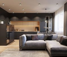 a living room filled with furniture next to a kitchen