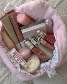 a pink bag filled with lots of different types of cosmetics